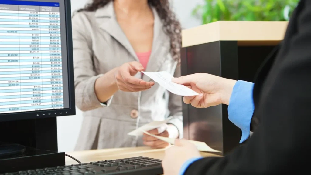 Bank Teller And Customer Banking Transaction In Retail Bank Counter 1024x577