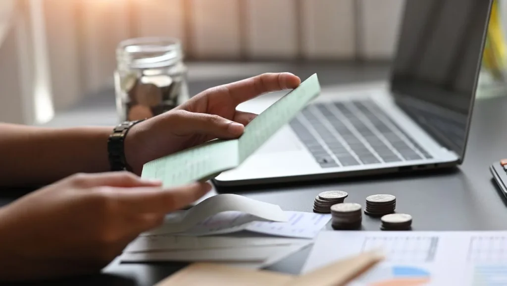 Person Looking Her Savings Account Bankbook 1024x577