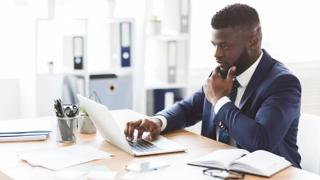 Young African American Entrepreneur Studying Competitors Online