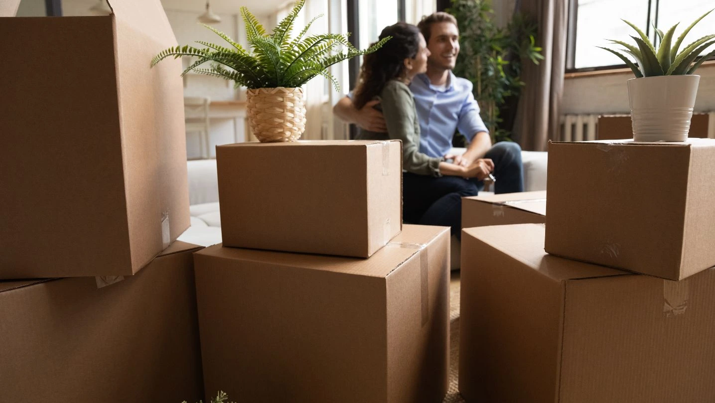 Young Couple First Time Realty Buyers Hug At New Home